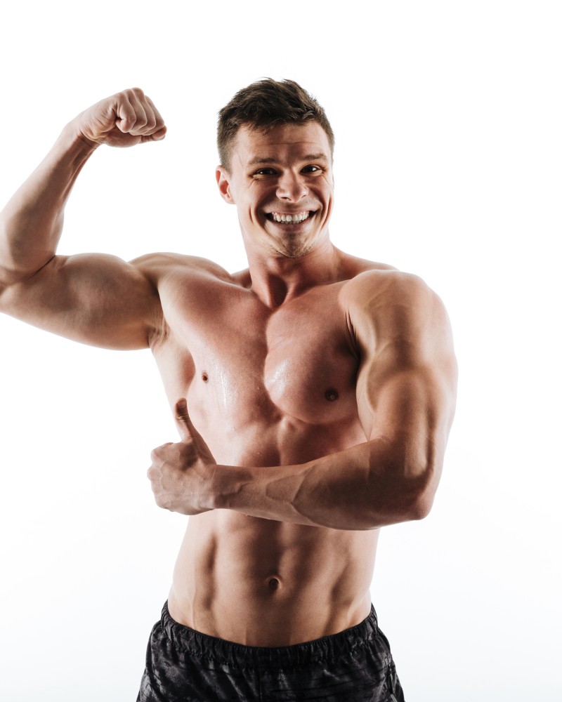portrait-young-laughing-muscular-man-showing-his-biceps-thumb-up-gesture (1)